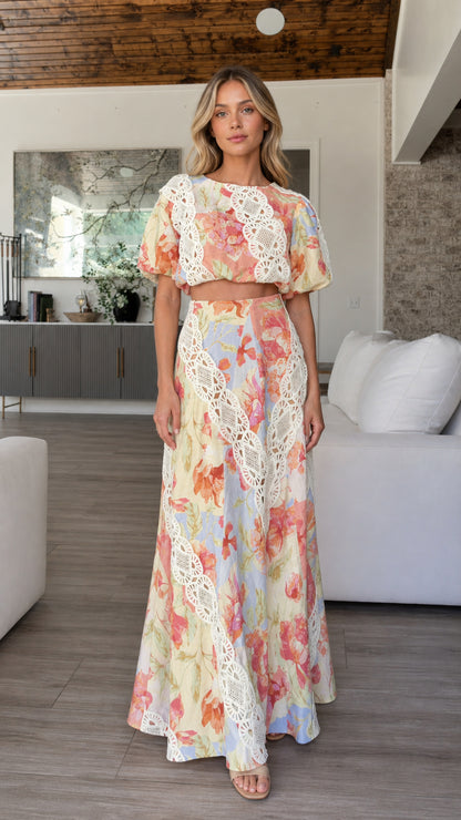 Front view of model wearing multi-color floral crop top and maxi skirt set with lace trim