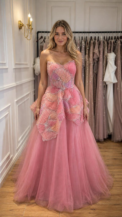 Front view of woman wearing pink strapless beaded tulle ball gown