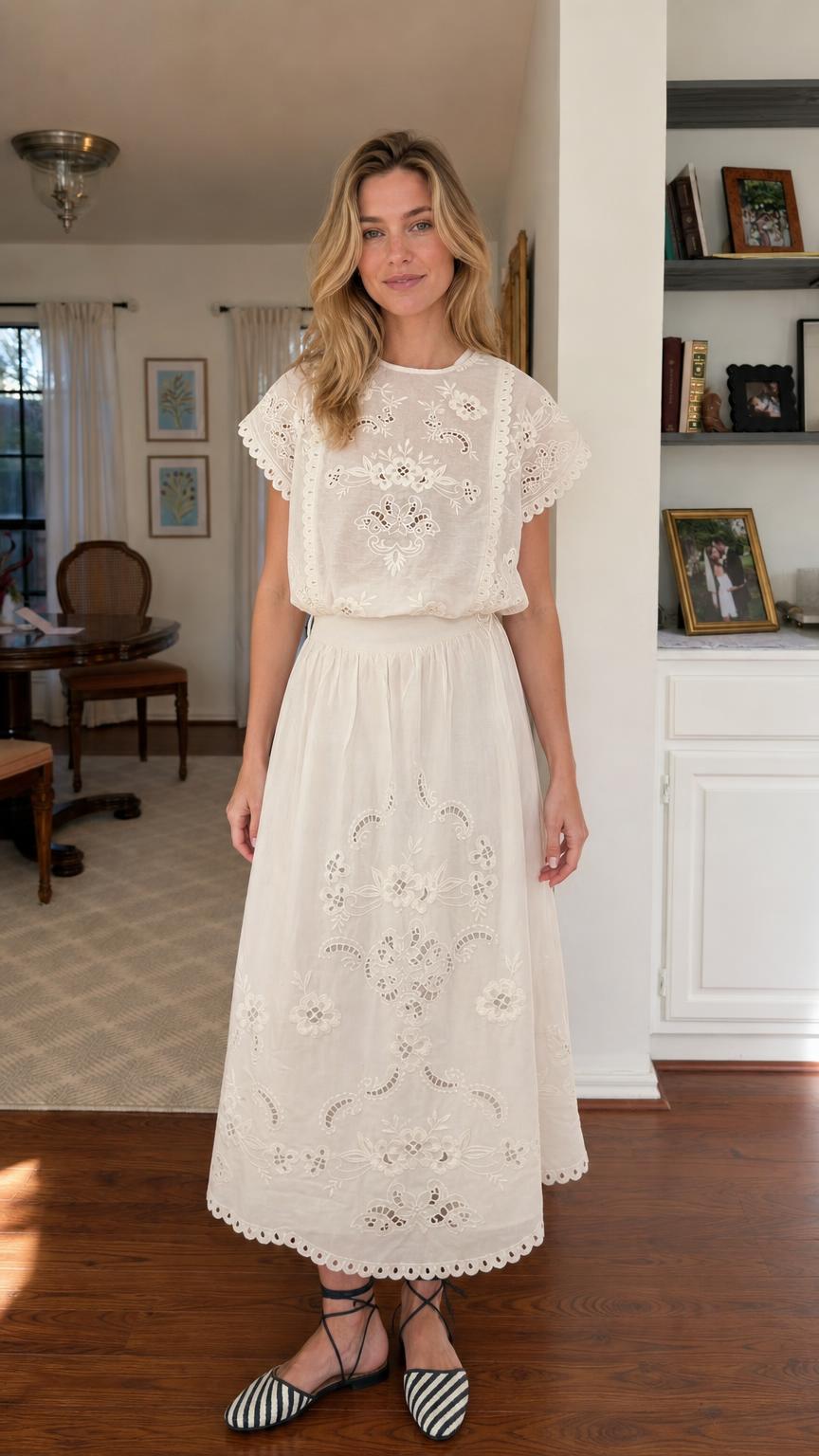 Front view of woman wearing white embroidered midi dress