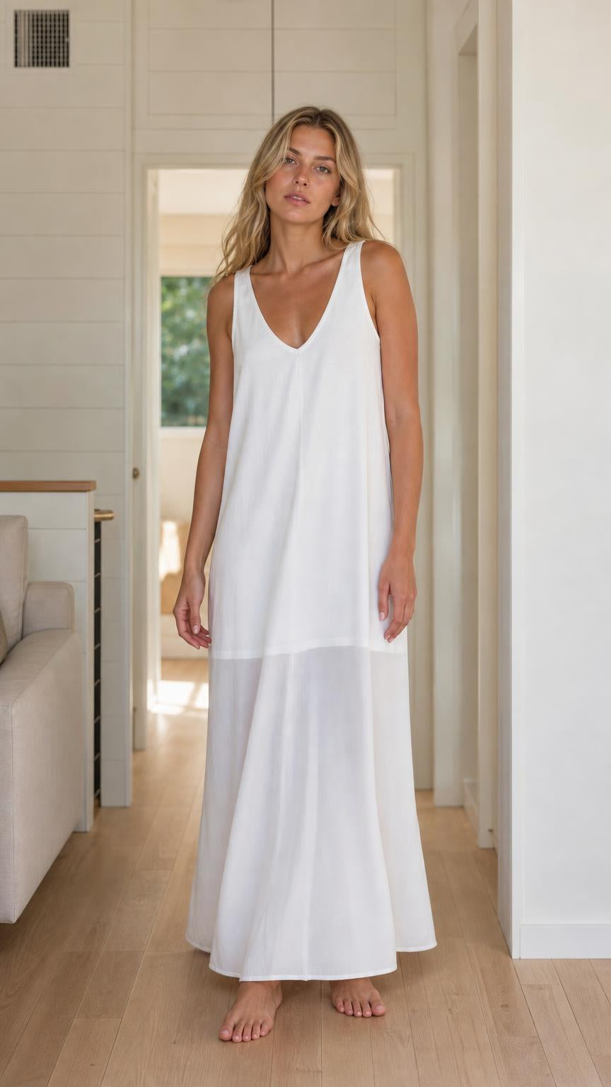 Front view of woman wearing white sleeveless maxi dress