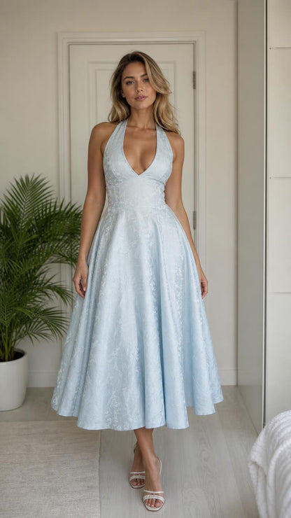 Full front view of model wearing light blue halter midi dress
