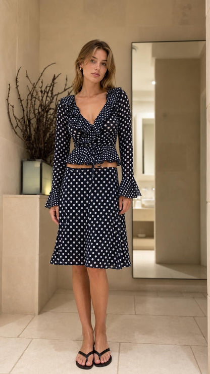 Front view of model wearing Navy Blue polka dot two piece set