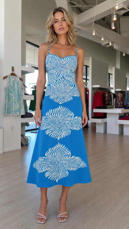 Front view of model wearing blue knit midi dress with abstract floral pattern