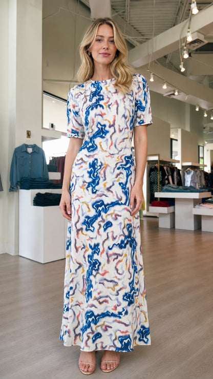 Front view of model wearing white abstract print maxi dress