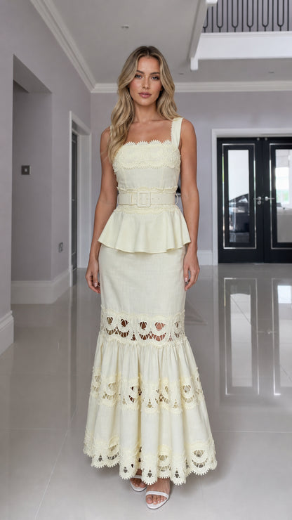 Front view of model wearing the yellow embroidered peplum maxi dress