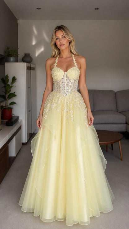 Front view of yellow halter embroidered tulle ball gown