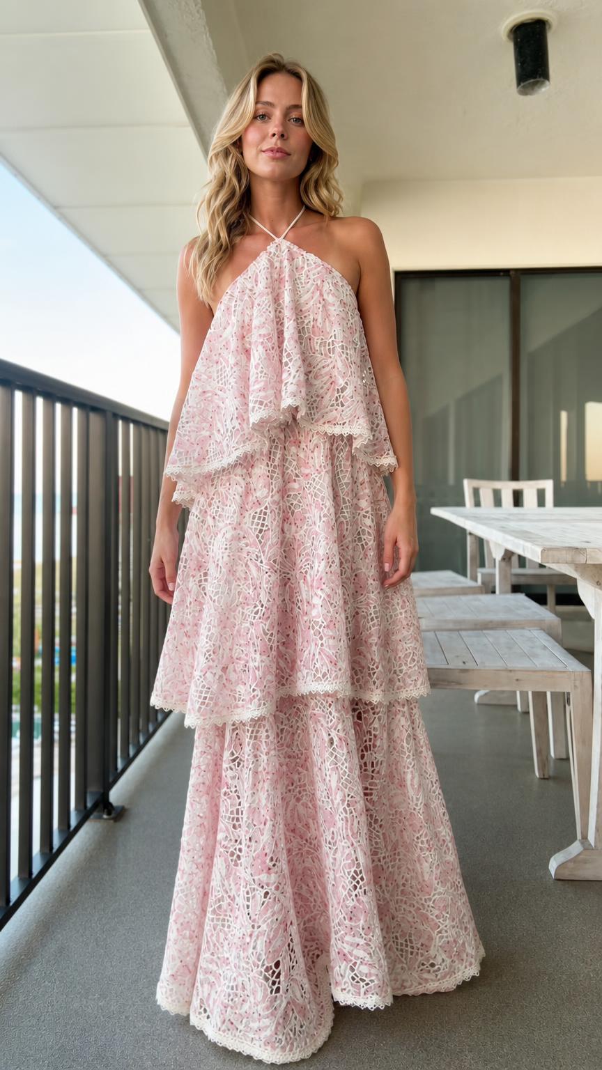 Front view of model wearing pink tiered halter lace maxi dress