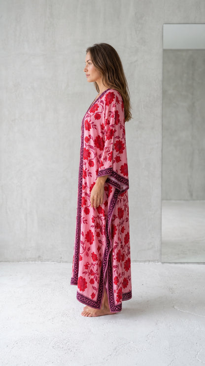 Side profile view of pink floral kaftan dress