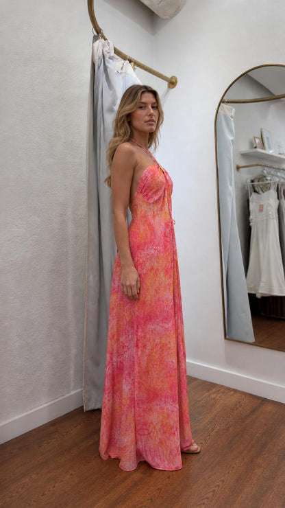 Model wearing pink boho halter maxi dress from the side profile