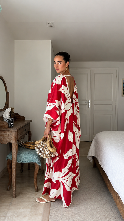 Side view of red tropical print caftan maxi dress showing open back detail