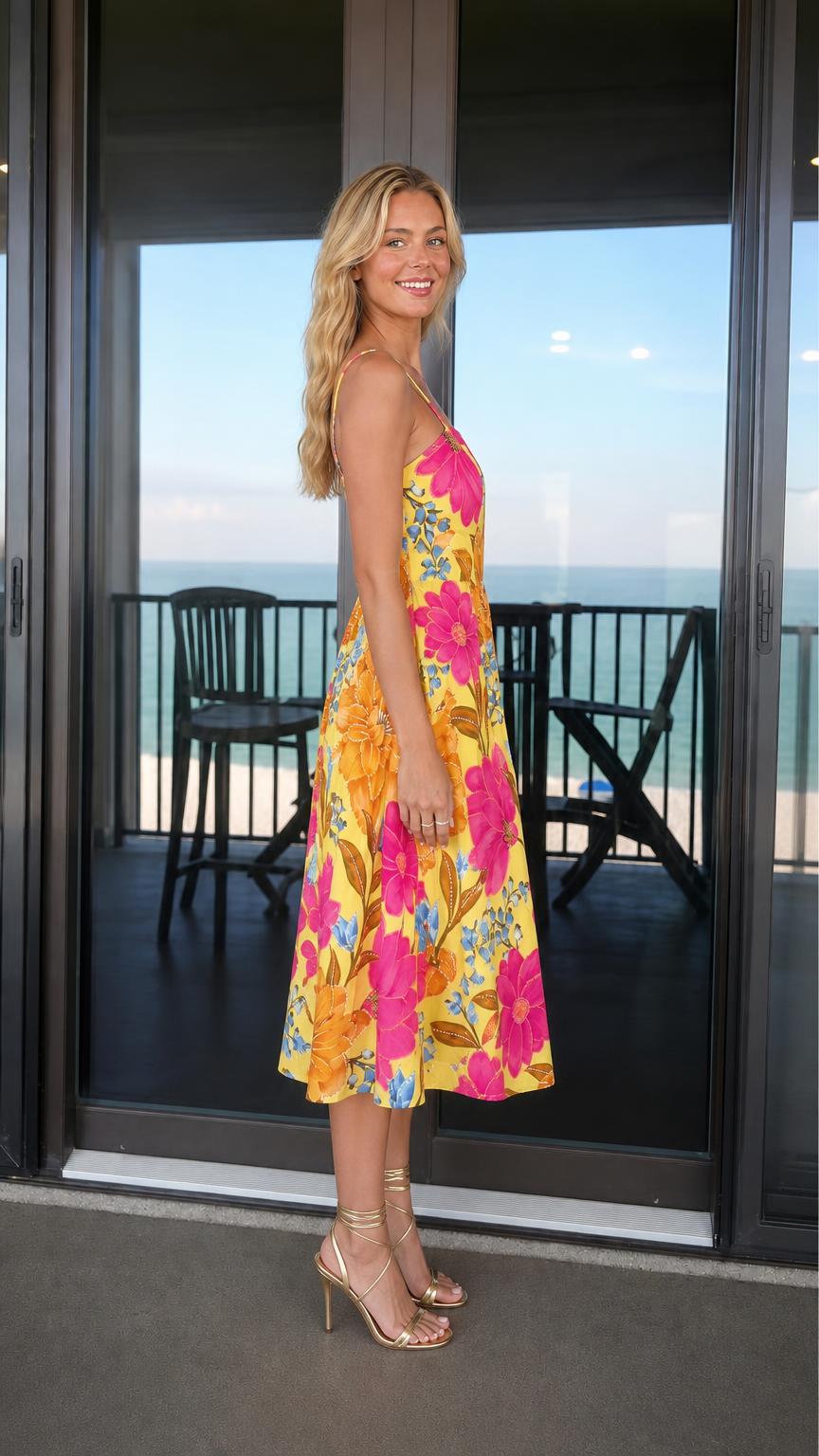 Side profile view of woman in yellow floral midi dress