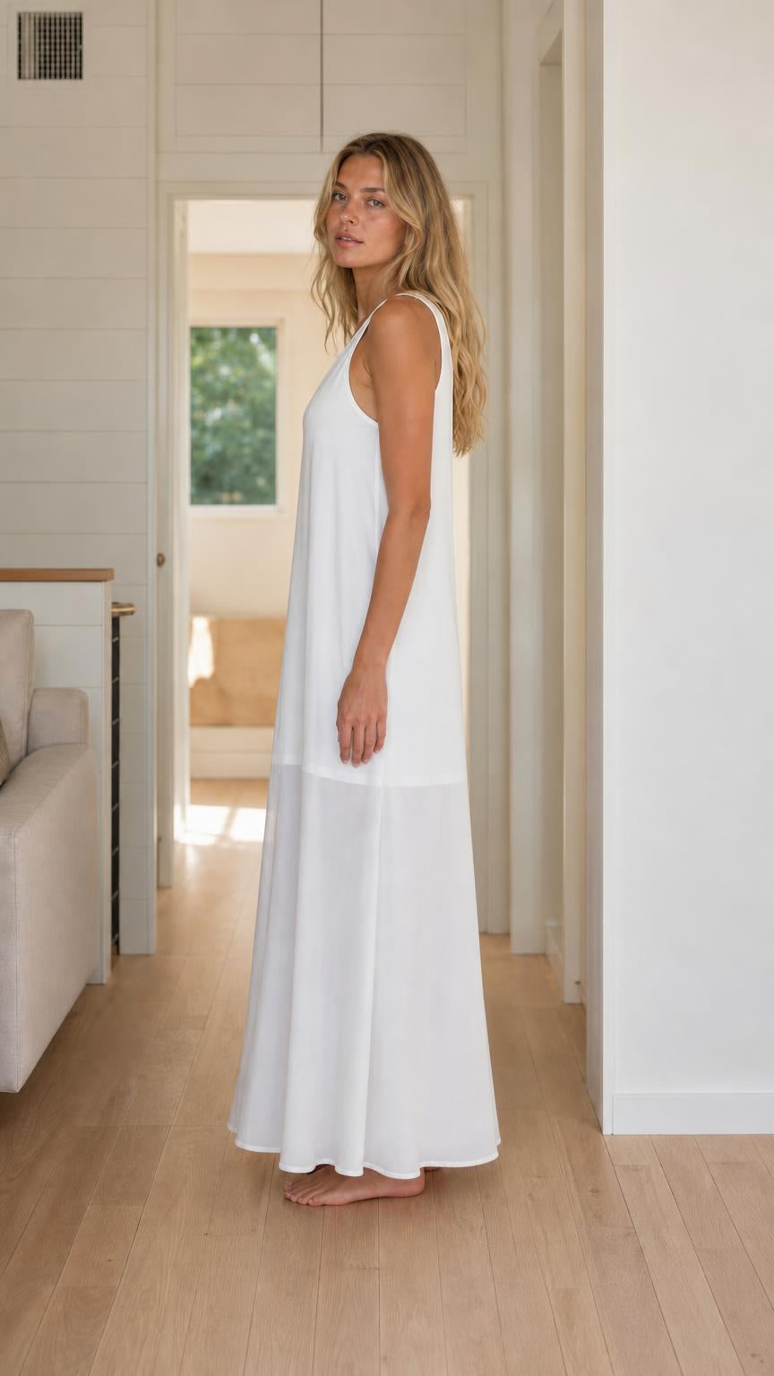 Side view of woman wearing white sleeveless maxi dress