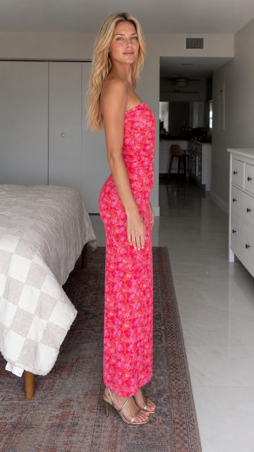 Side view of woman wearing hot pink strapless floral maxi dress