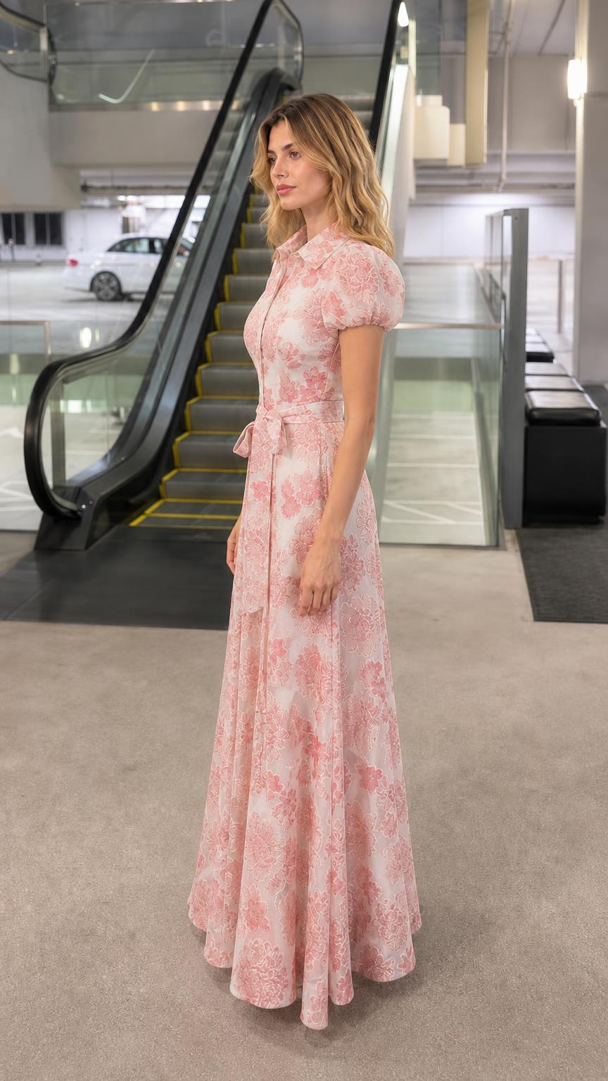 Side profile view of woman in pink floral maxi dress