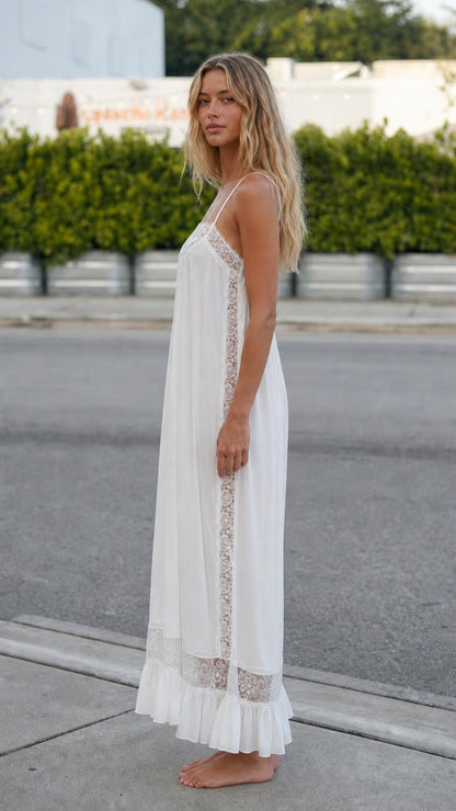 Side profile view of model in white maxi dress