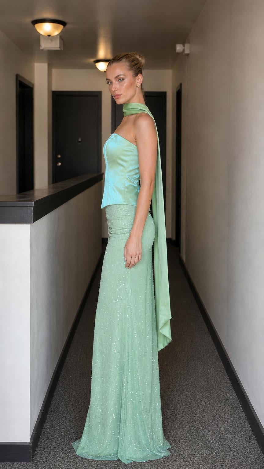 Side profile of model in sage evening gown set