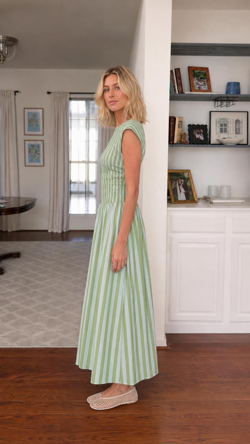 Side view of woman wearing green striped smocked maxi dress
