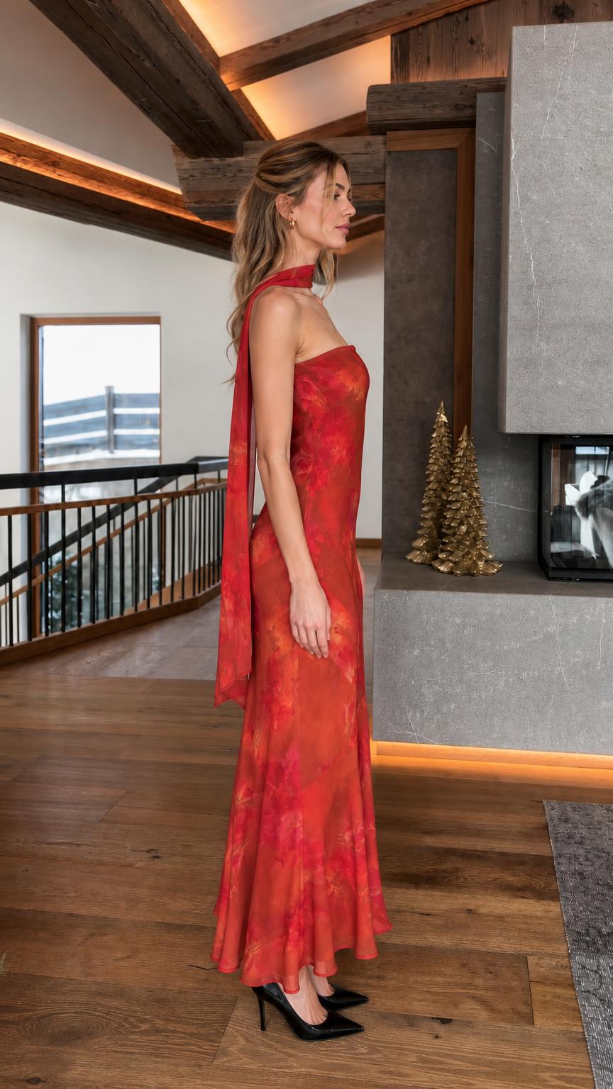 Woman wearing red floral strapless maxi dress side view