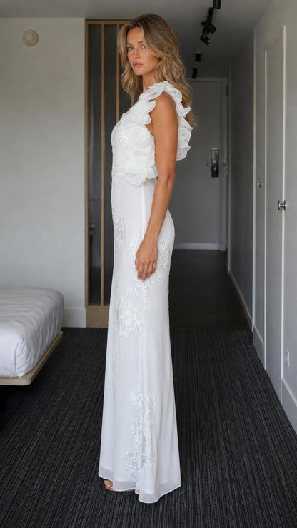 Side profile view of white one-shoulder gown