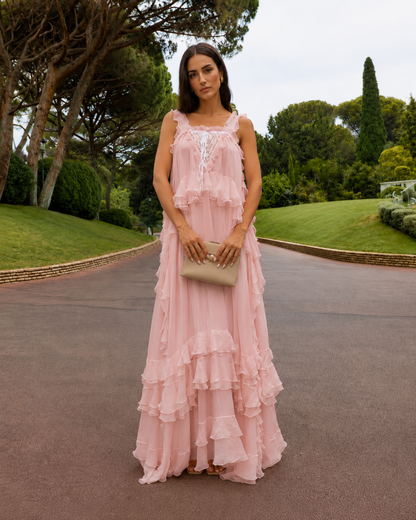 Front view of blush pink flowing maxi dress with lace-look bodice and ruffle layers