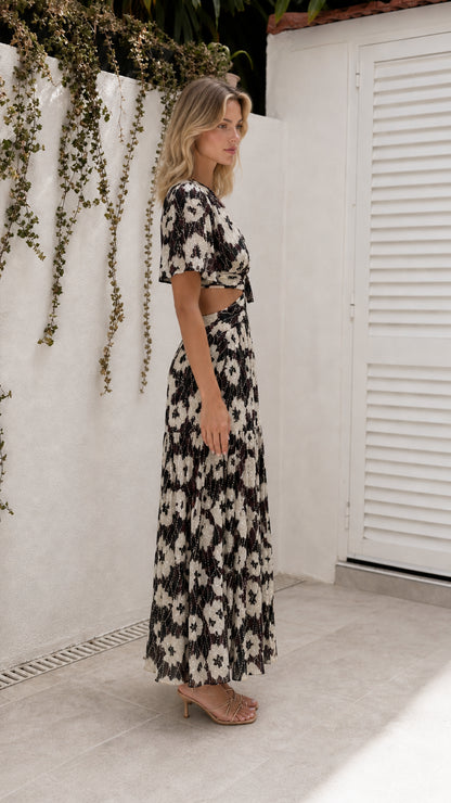 Side view of model wearing black floral cutout maxi dress