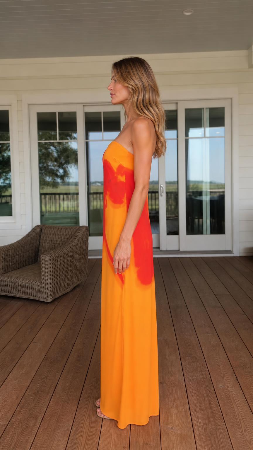 Side view of woman in orange maxi dress
