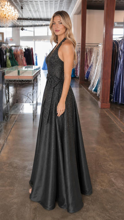 Side profile of model wearing black glitter evening dress
