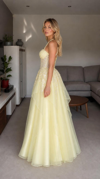Side view of yellow halter embroidered tulle ball gown