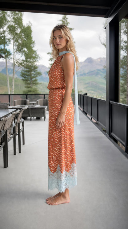 Side profile of rust orange printed maxi dress