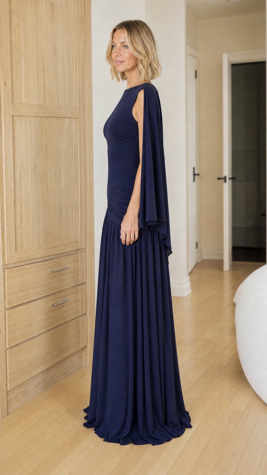 Side profile view of navy blue evening gown with draping sleeves