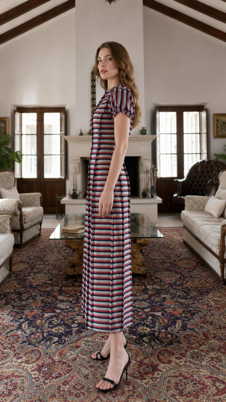 Side profile view of model in multi-stripe maxi dress
