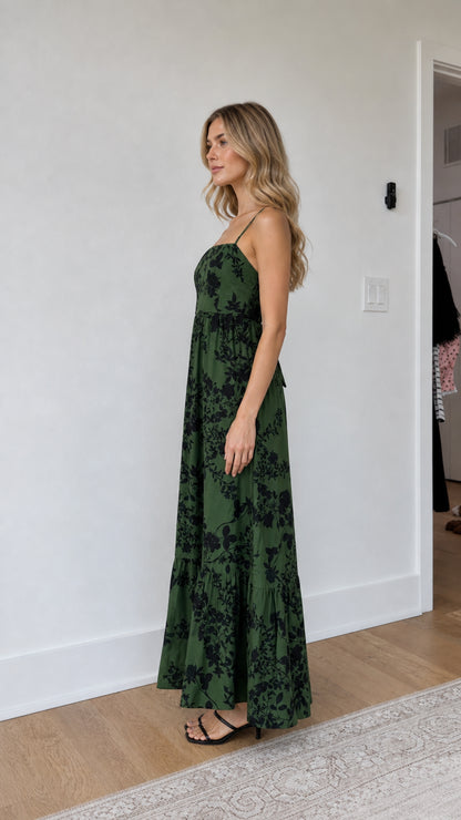 Side profile of model wearing green floral maxi dress