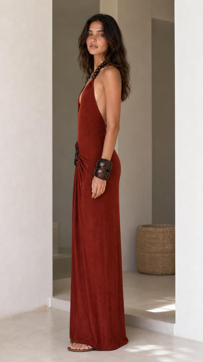 Model showcasing side profile of rust maxi dress
