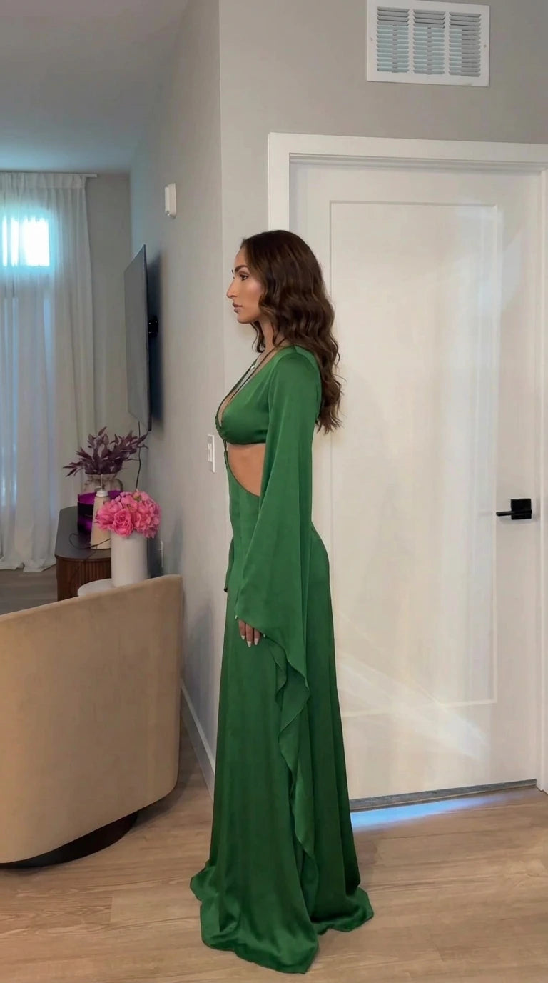 Side profile view of model in green evening gown