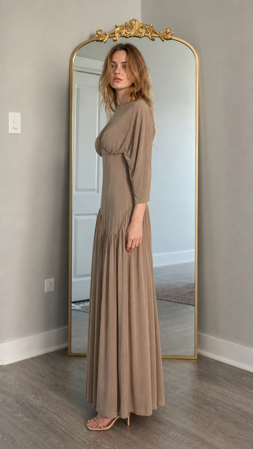 Side profile of model in taupe maxi dress showing fitted bodice