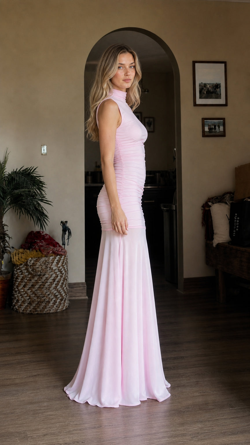 Side profile view of model wearing pink ruched mermaid dress