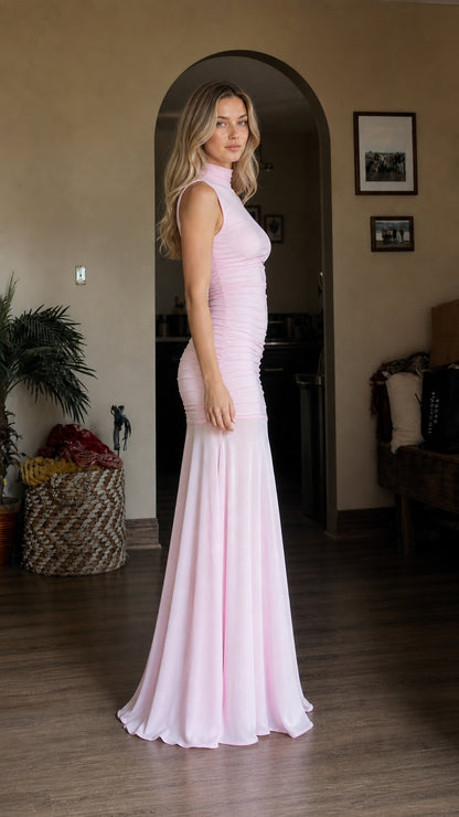 Side profile view of model wearing pink ruched mermaid dress