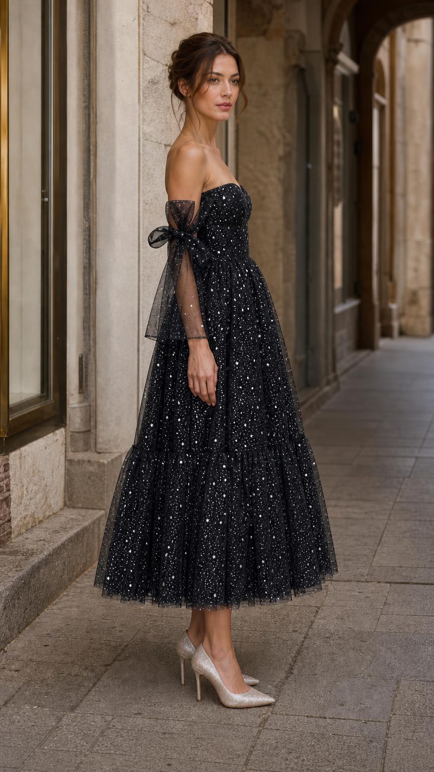 Side profile view of model in black tulle evening dress with heels