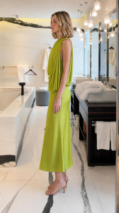 Side profile of woman wearing Lime Green draped midi dress