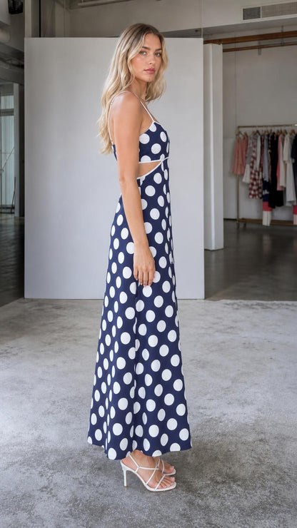 Side view of navy polka dot maxi dress