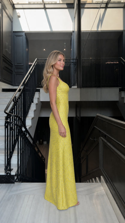 Side profile view of yellow lace evening dress