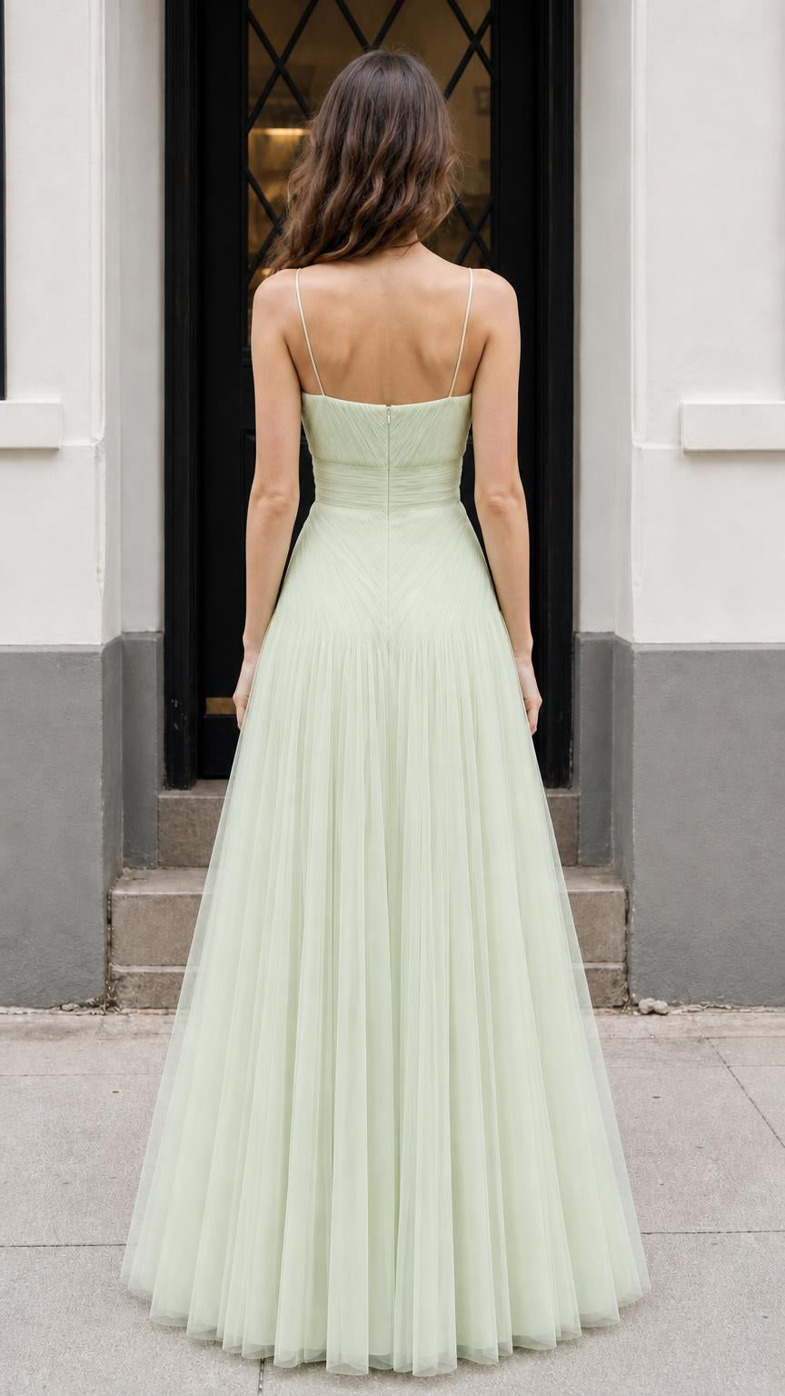 Back view of model showing lace-up strap detail on sage dress