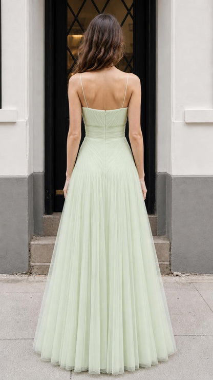 Back view of model showing lace-up strap detail on sage dress