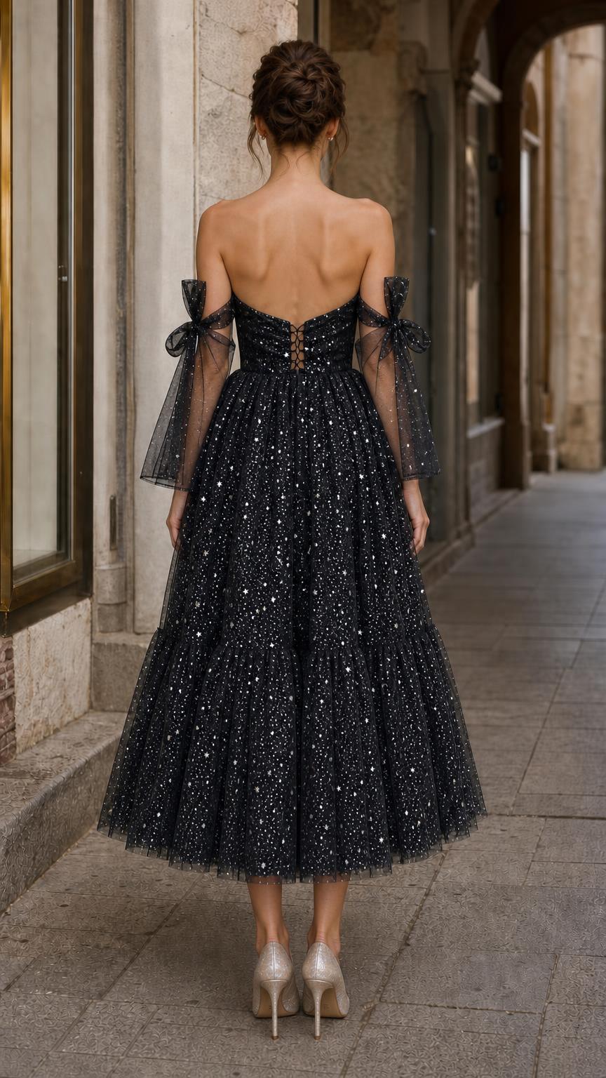Back view showing corset-style lace-up back detail on black dress