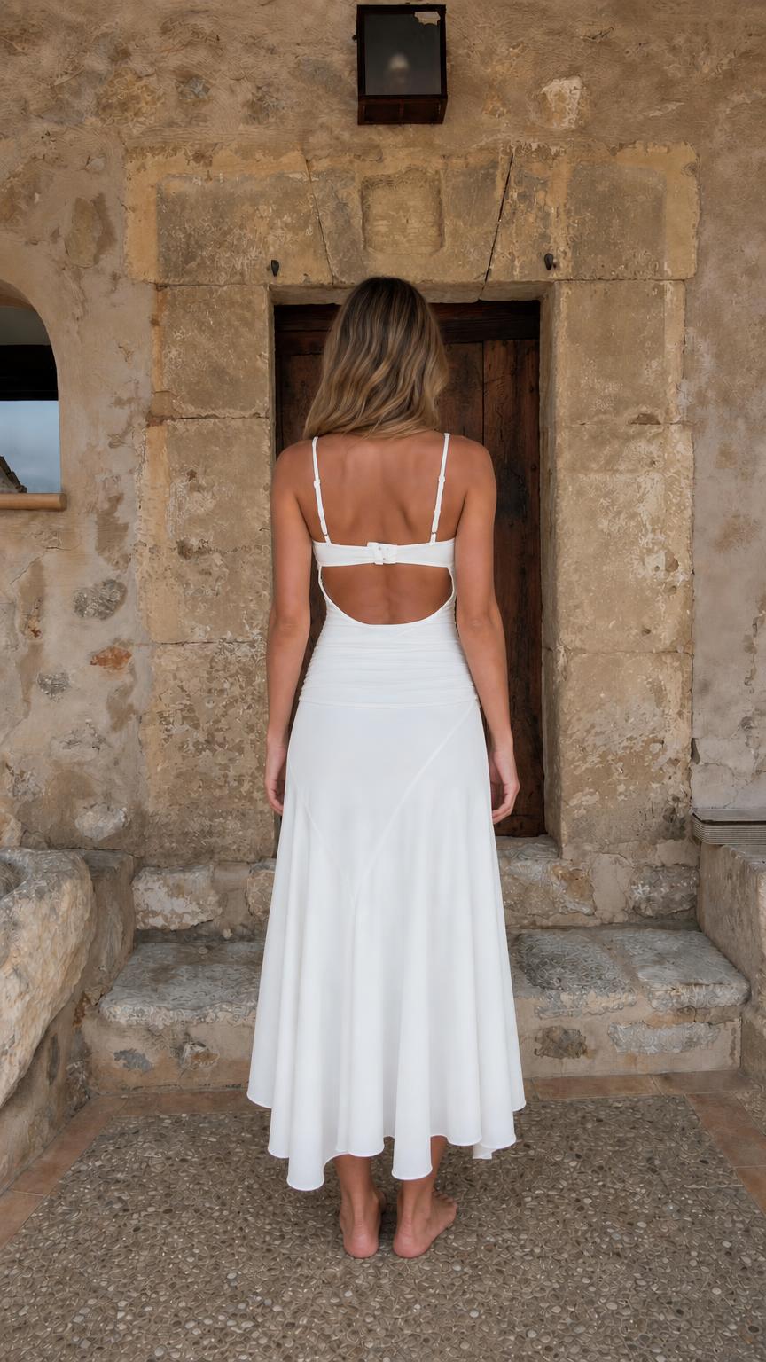 Back view of woman showing open back detail on white dress