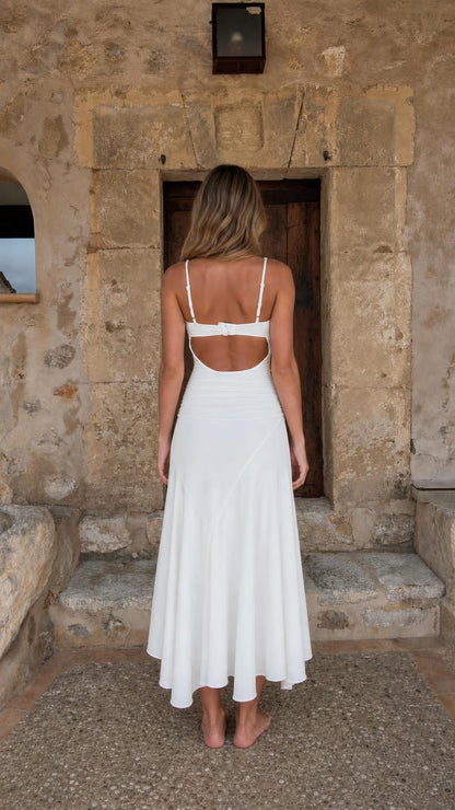 Back view of woman showing open back detail on white dress