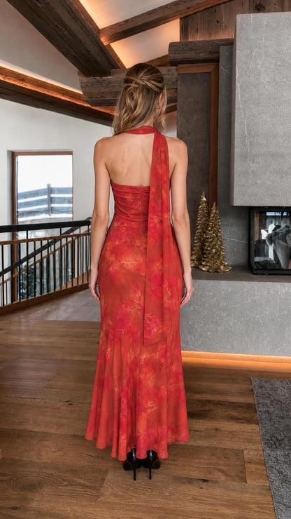 Woman wearing red floral strapless maxi dress back view