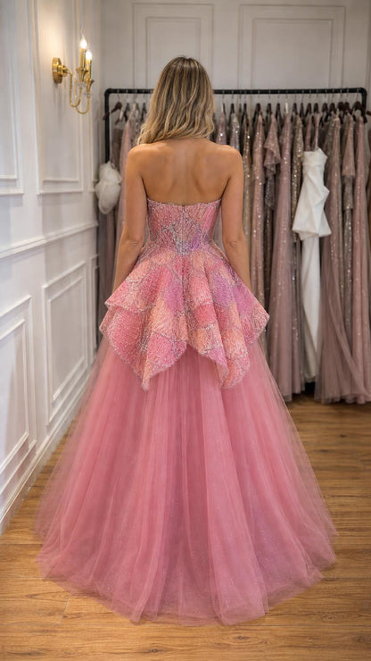 Back view of woman wearing pink strapless beaded tulle ball gown