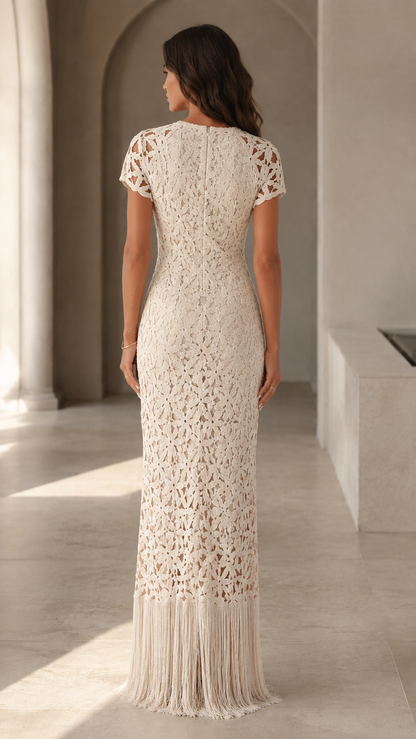 Back view of cream short sleeve crochet-look maxi dress with floor-length fringe hem