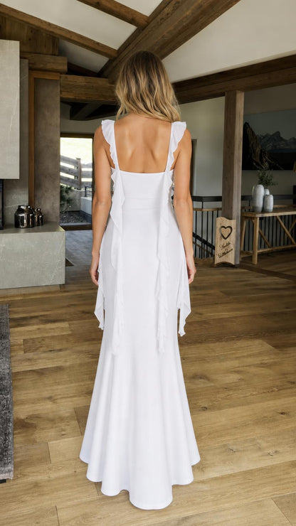 Back view of model in white ruffled maxi dress